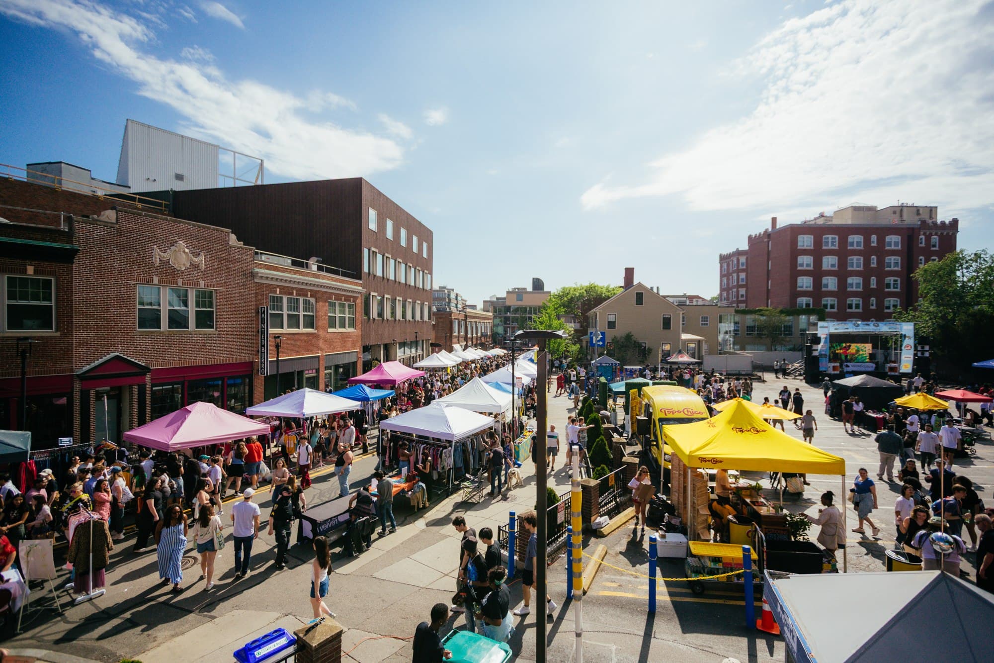 Select Markets vendors and visitors filling a sunny neighborhood street